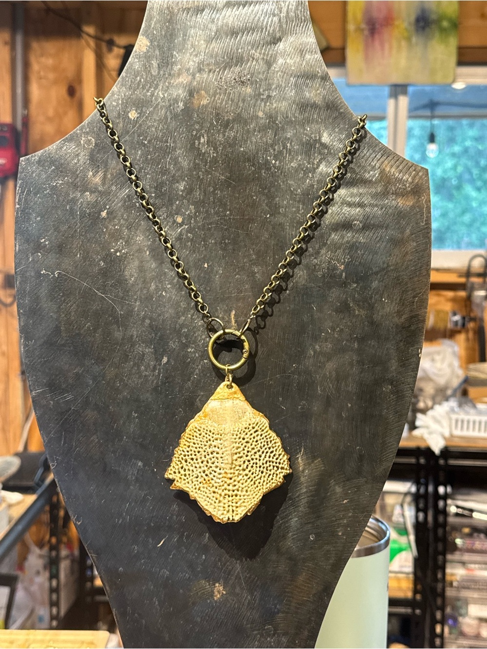 Bronze chain with a Sturgeon vertebrae pendant.